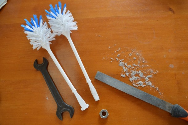 Brush on left with filed down handle and thread.